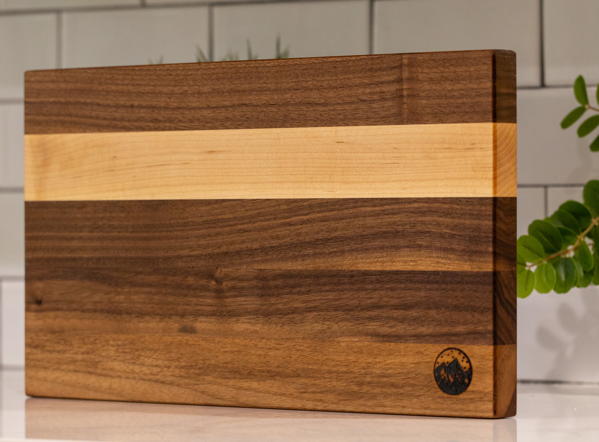 Walnut cutting board with a maple stripe